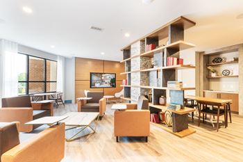 A living room filled with furniture and a book shelf